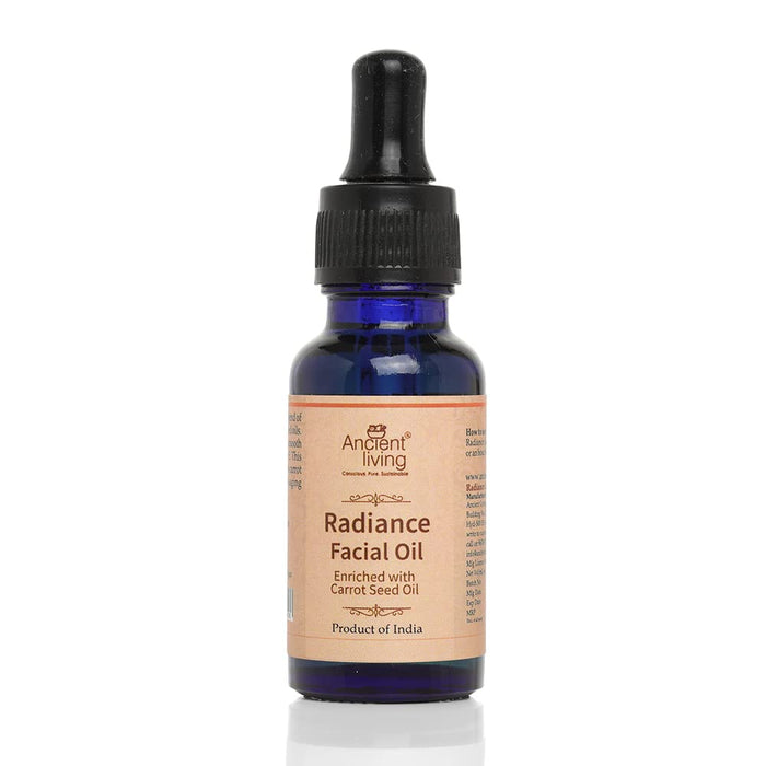 A blue glass bottle with a black dropper labeled 'Radiance Facial Oil' by Ancient Living.